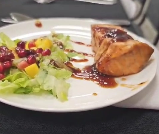 Salmon cubes over bed of lettuce laced with teriyaki sauce